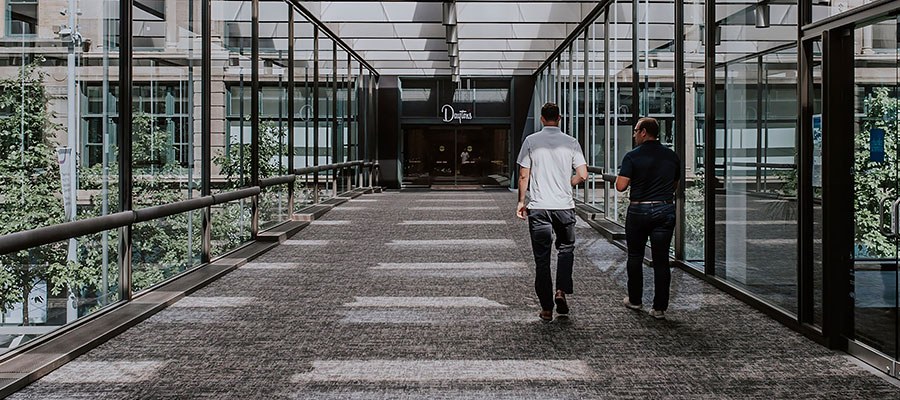 two men walking in skyway